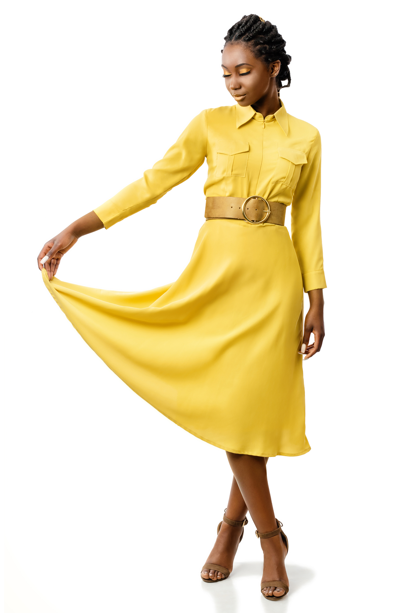 Full length portrait of attractive young african american girl in stylish yellow dress. Elegant woman holding end of dress with eyes closed.Isolated on white background.